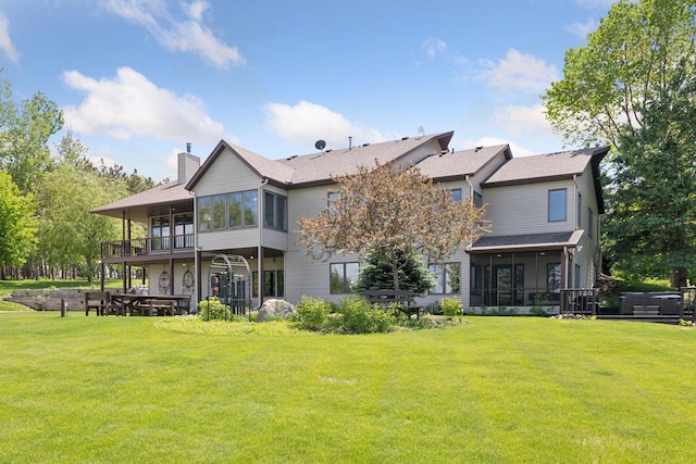32875 Stanton Trl, Cannon Falls, MN 55009 - back of property with a sunroom, a lawn, a chimney, and a hot tub