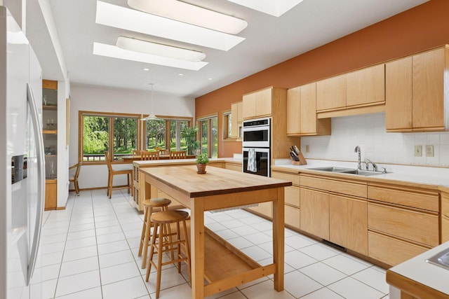 32875 Stanton Trl, Cannon Falls, MN 55009 - kitchen featuring a sink, white appliances, light brown cabinets, a skylight, and recessed lighting