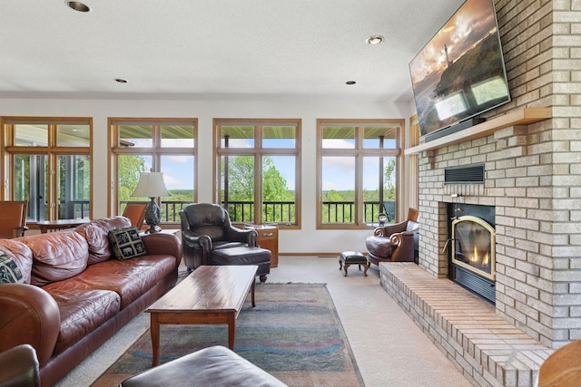 32875 Stanton Trl, Cannon Falls, MN 55009 - carpeted living room with a brick fireplace, healthy amount of natural light, baseboards, recessed lighting, and a textured ceiling