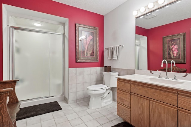 32875 Stanton Trl, Cannon Falls, MN 55009 - bathroom featuring vanity, a shower stall, tile walls, toilet, and tile patterned flooring