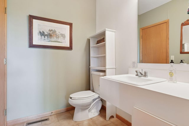 32875 Stanton Trl, Cannon Falls, MN 55009 - bathroom featuring tile patterned flooring, toilet, baseboards, and vanity