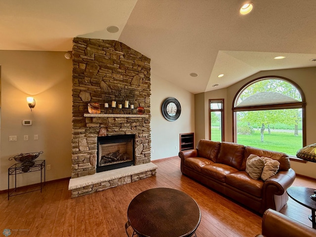 3823 43rd Ave S, Moorhead, MN 56560 - living area featuring vaulted ceiling, wood finished floors, and a stone fireplace