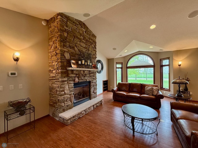 3823 43rd Ave S, Moorhead, MN 56560 - living area featuring hardwood / wood-style flooring, vaulted ceiling, a fireplace, and baseboards