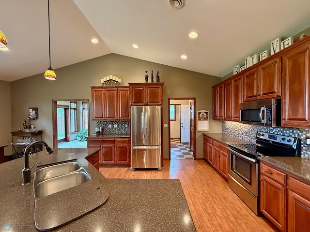 3823 43rd Ave S, Moorhead, MN 56560 - kitchen with stainless steel appliances, a sink, lofted ceiling, decorative backsplash, and light wood-type flooring
