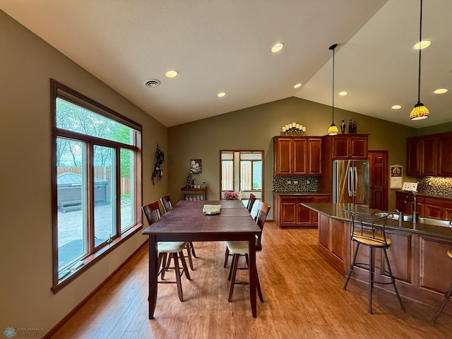 3823 43rd Ave S, Moorhead, MN 56560 - dining space featuring light wood-style floors, healthy amount of natural light, vaulted ceiling, and recessed lighting