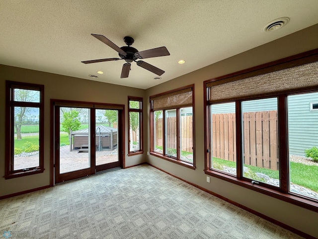 3823 43rd Ave S, Moorhead, MN 56560 - unfurnished sunroom featuring baseboards, carpet, a textured ceiling, and recessed lighting