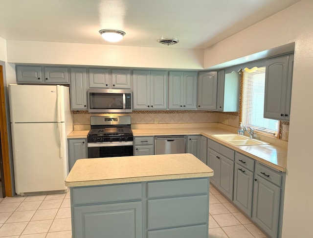 1611 Graydon Ave, Brainerd, MN 56401 - kitchen featuring stainless steel appliances, gray cabinets, light tile patterned floors, backsplash, and light countertops