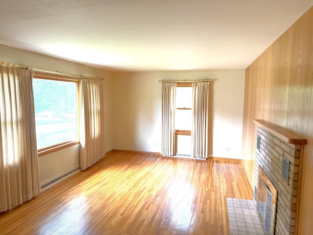 1611 Graydon Ave, Brainerd, MN 56401 - unfurnished living room featuring a brick fireplace and light wood-type flooring
