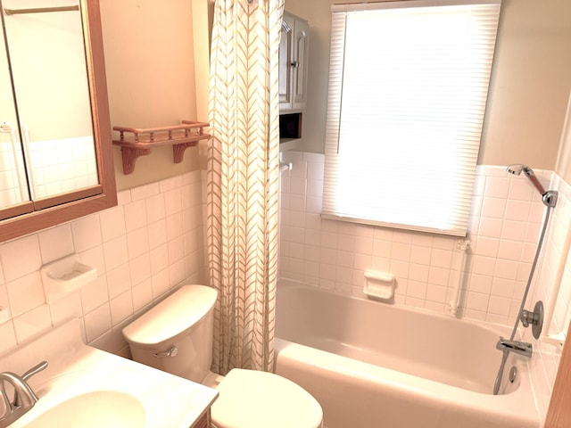 1611 Graydon Ave, Brainerd, MN 56401 - full bath featuring tile walls, shower / tub combo, wainscoting, vanity, and healthy amount of natural light