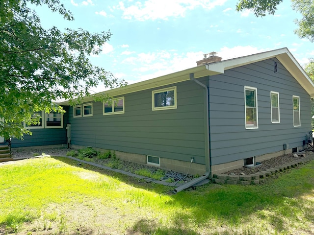 1611 Graydon Ave, Brainerd, MN 56401 - view of side of home featuring a chimney and a lawn