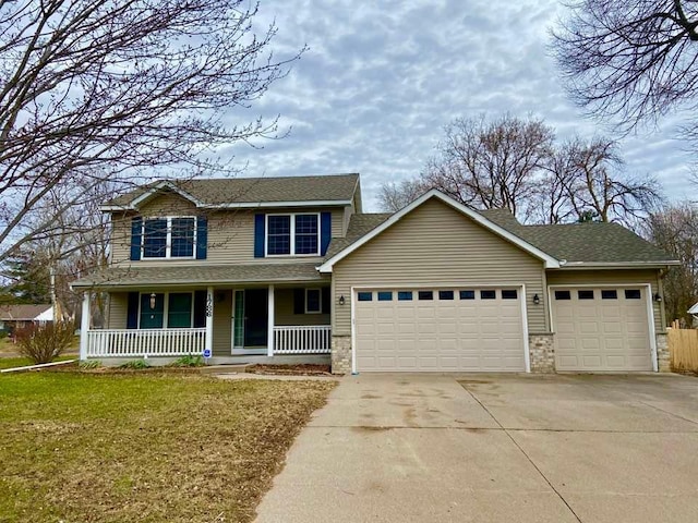 traditional home with an attached garage, driveway, covered porch, a front yard, and a shingled roof