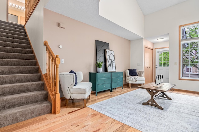 living area with stairway and light wood-style floors