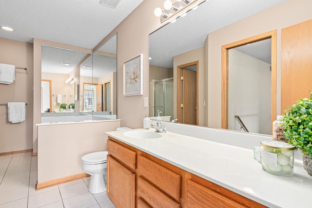 full bath with a stall shower, tile patterned flooring, vanity, a textured ceiling, and toilet