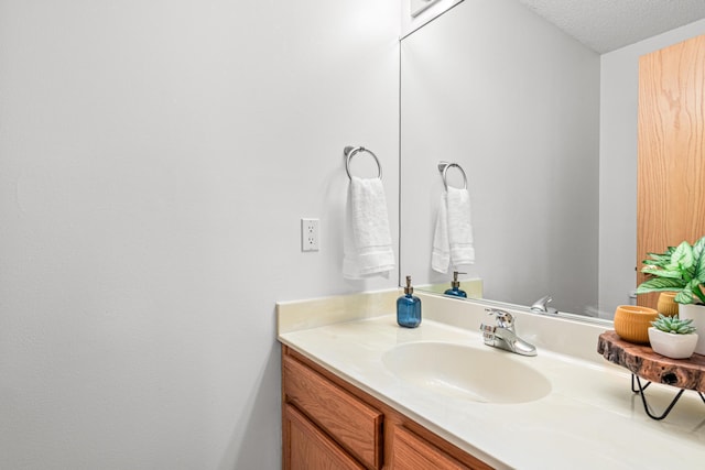 bathroom featuring vanity and a textured ceiling