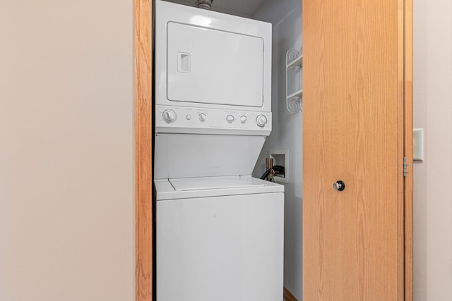 washroom with stacked washer / drying machine