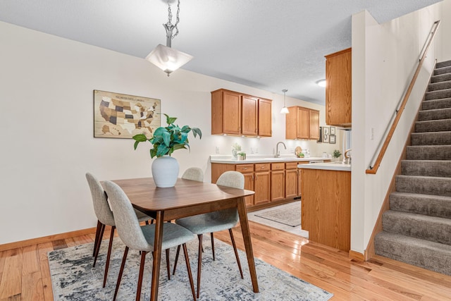 717 Grandview Way, Hudson, WI 54016 - dining space with stairs, baseboards, and light wood-type flooring