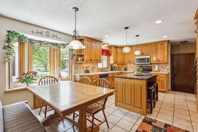 5651 164th Ln NW, Ramsey, MN 55303 - kitchen with stainless steel microwave, black range oven, open shelves, a kitchen island, and tasteful backsplash