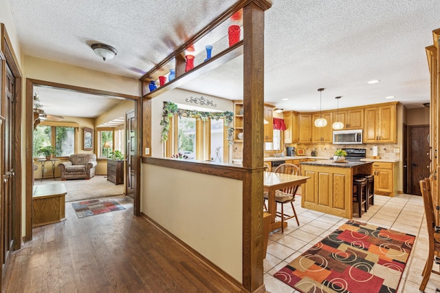 5651 164th Ln NW, Ramsey, MN 55303 - corridor with a textured ceiling, recessed lighting, and light tile patterned floors