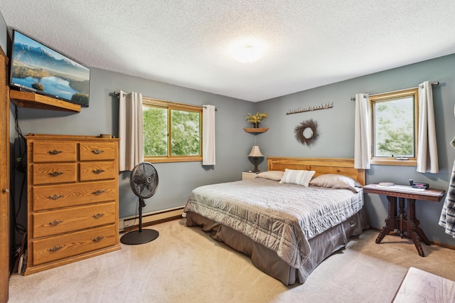 5651 164th Ln NW, Ramsey, MN 55303 - bedroom with baseboard heating, carpet flooring, and a textured ceiling