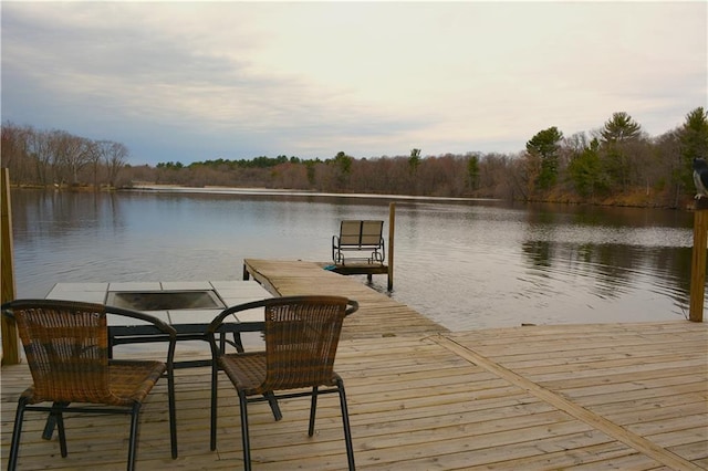 dock featuring a water view and a forest view