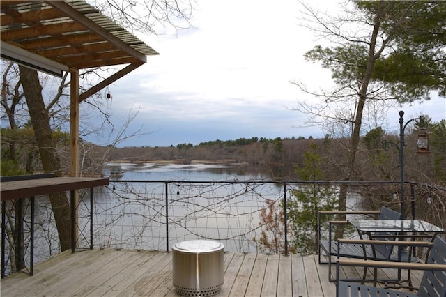 wooden deck featuring a water view and a forest view