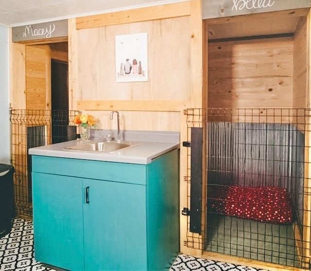 bathroom featuring wooden walls and vanity