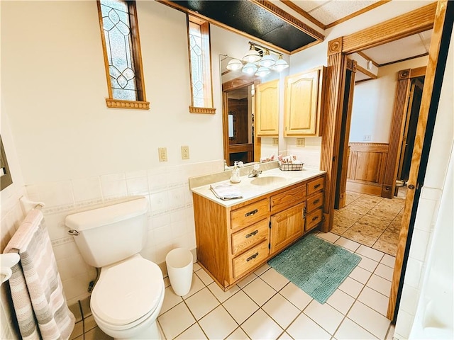 bathroom with wainscoting, toilet, and vanity