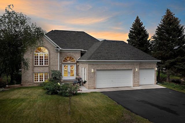 2001 Stonepine Ave, Hudson, WI 54016 - traditional home featuring french doors, asphalt driveway, brick siding, and a yard