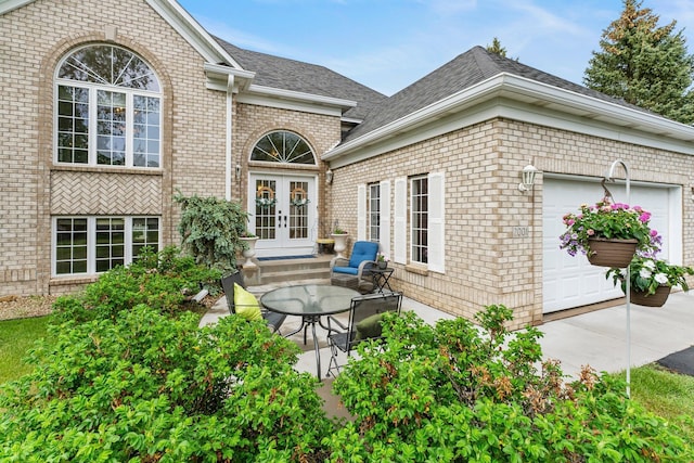 2001 Stonepine Ave, Hudson, WI 54016 - doorway to property with french doors, brick siding, roof with shingles, and a garage