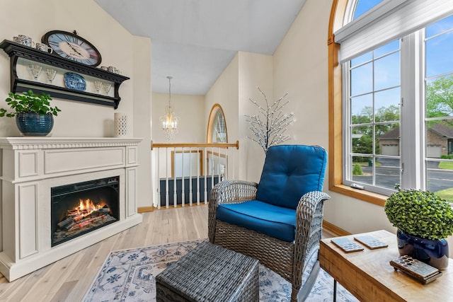 2001 Stonepine Ave, Hudson, WI 54016 - living area featuring plenty of natural light, a chandelier, light wood-style flooring, baseboards, and vaulted ceiling