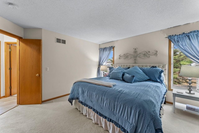 2001 Stonepine Ave, Hudson, WI 54016 - bedroom with a textured ceiling, light colored carpet, and baseboards