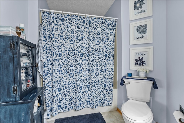 2001 Stonepine Ave, Hudson, WI 54016 - full bath featuring a textured ceiling, toilet, tile patterned flooring, and shower / tub combo with curtain