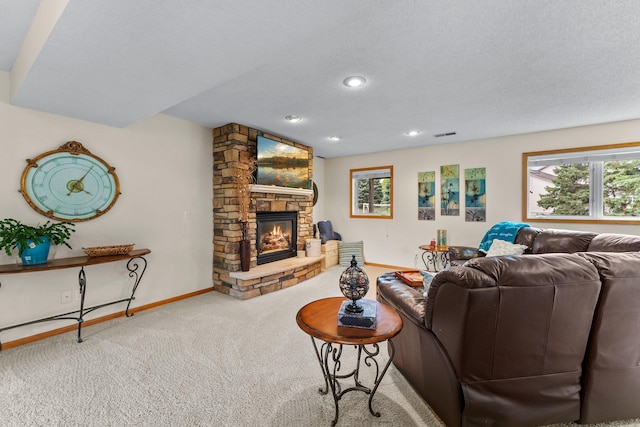 2001 Stonepine Ave, Hudson, WI 54016 - living room featuring a stone fireplace, carpet flooring, baseboards, and recessed lighting