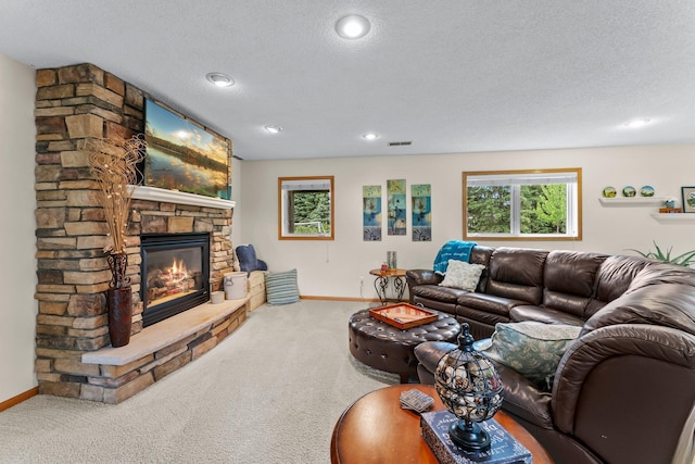 2001 Stonepine Ave, Hudson, WI 54016 - carpeted living area with a fireplace, baseboards, a textured ceiling, and recessed lighting