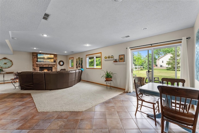 2001 Stonepine Ave, Hudson, WI 54016 - living room featuring a stone fireplace, a textured ceiling, baseboards, and recessed lighting