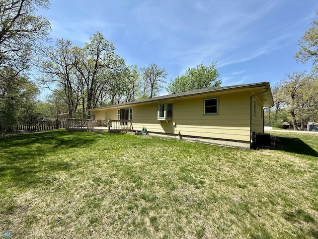 6914 1st St N, Moorhead, MN 56560 - back of house with a wooden deck and a lawn