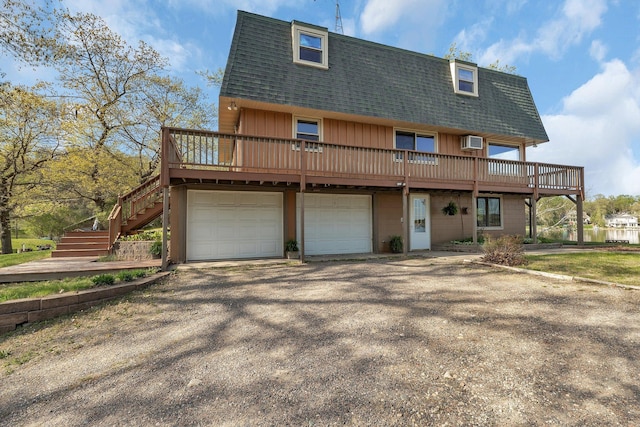 6032 Quinn Ave NW, Annandale, MN 55302 - view of front of property with a shingled roof, a garage, mansard roof, a deck, and stairs