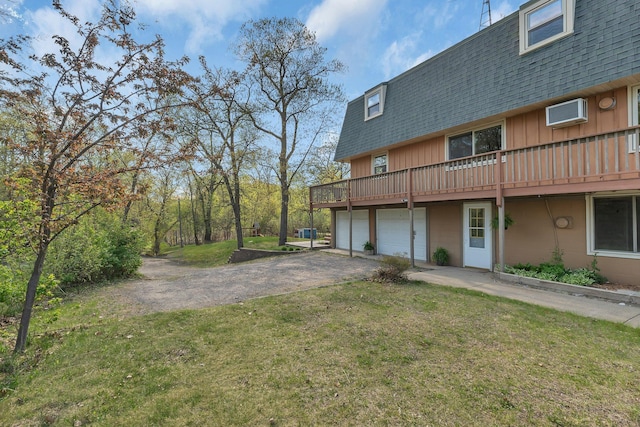 6032 Quinn Ave NW, Annandale, MN 55302 - rear view of house with roof with shingles, an attached garage, driveway, and a yard