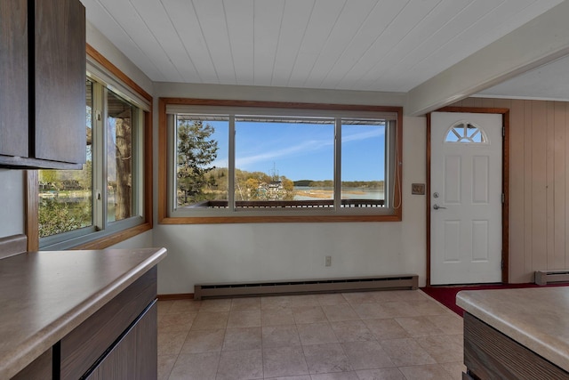 6032 Quinn Ave NW, Annandale, MN 55302 - unfurnished dining area with a baseboard heating unit, a baseboard radiator, plenty of natural light, and baseboards