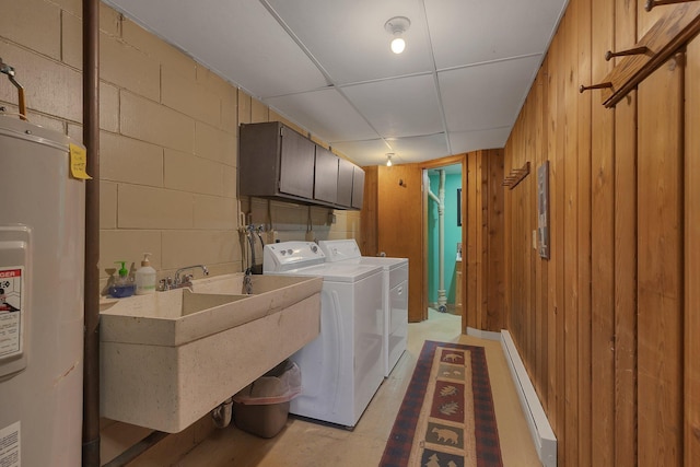 6032 Quinn Ave NW, Annandale, MN 55302 - laundry room featuring electric water heater, cabinet space, baseboard heating, washer and clothes dryer, and concrete block wall