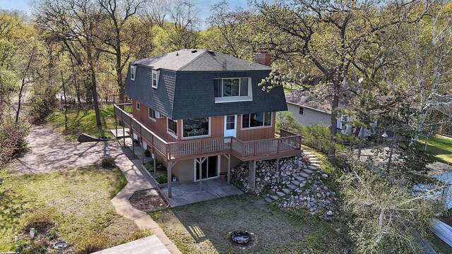 6032 Quinn Ave NW, Annandale, MN 55302 - view of front of property with a patio area, a gambrel roof, a deck, a chimney, and roof with shingles
