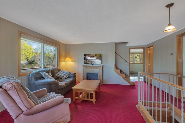 6032 Quinn Ave NW, Annandale, MN 55302 - carpeted living area featuring a fireplace, wood walls, and stairs