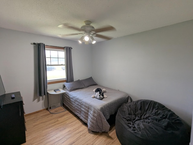 bedroom with light wood-style flooring and ceiling fan