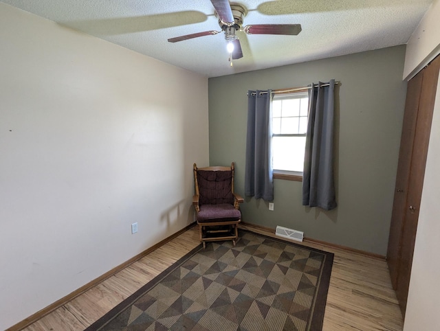 unfurnished room with ceiling fan, wood finished floors, and baseboards