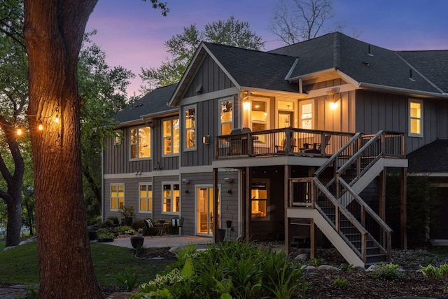 648 Sunset Ln, Mendota Heights, MN 55118 - back of property at dusk with a patio area, board and batten siding, roof with shingles, stairs, and a wooden deck
