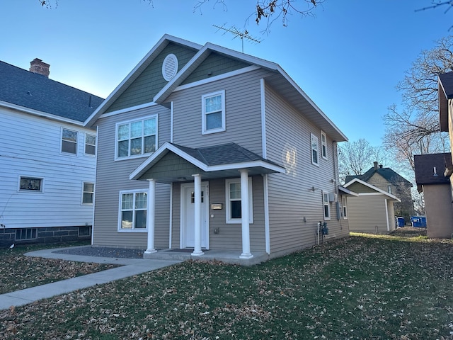 view of front of home with a porch and a front lawn