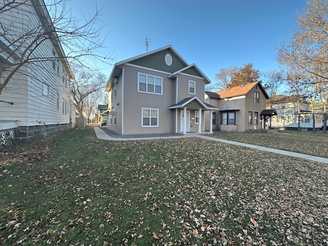 traditional-style home with a front lawn