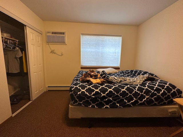 carpeted bedroom featuring a baseboard radiator, an AC wall unit, and a closet