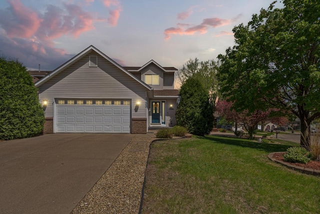 2200 15 1/2 St NW, Faribault, MN 55021 - traditional home featuring driveway, brick siding, a front lawn, and a garage