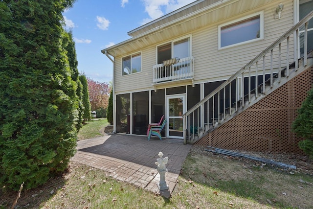 2200 15 1/2 St NW, Faribault, MN 55021 - rear view of house featuring a patio, a sunroom, and stairs